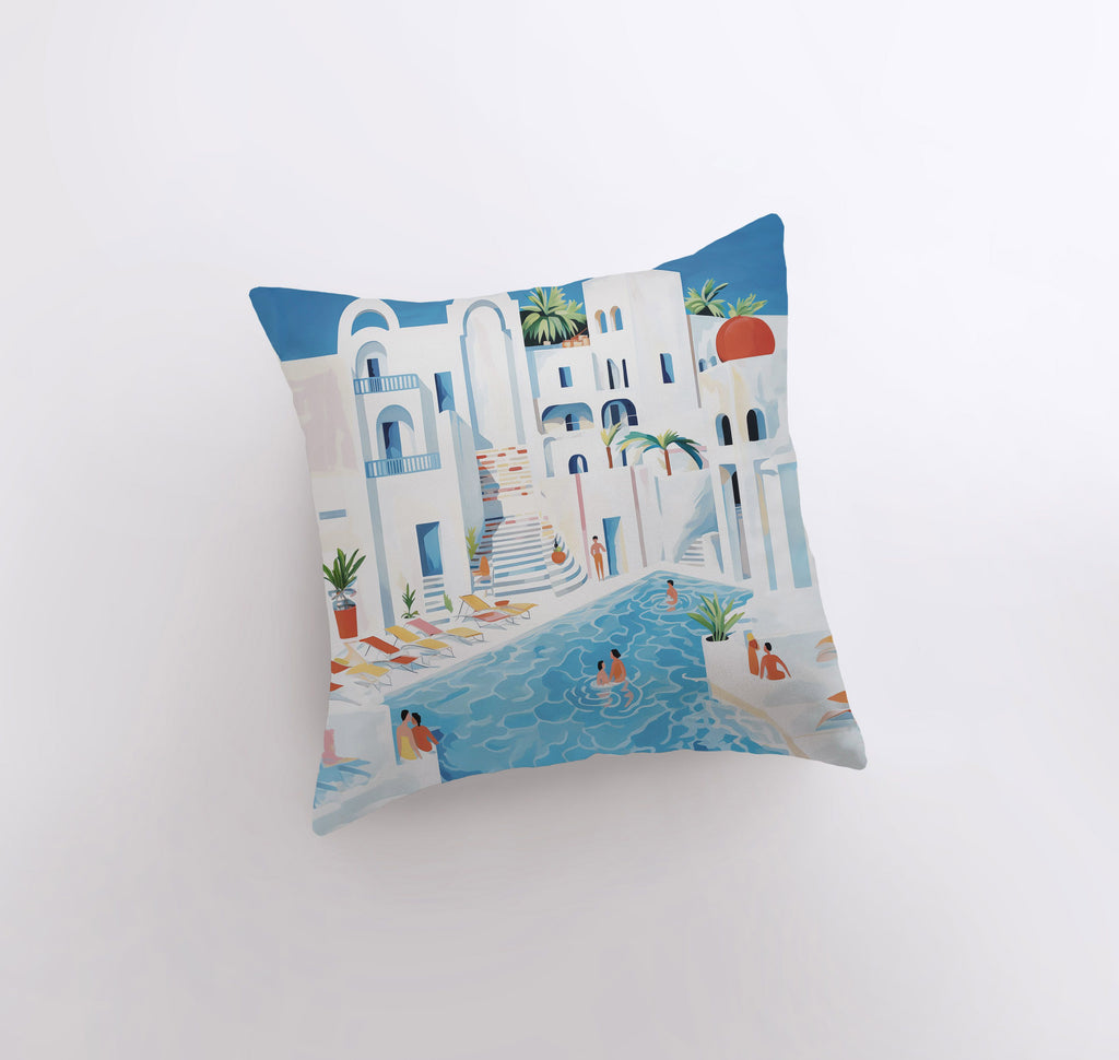 a blue and white pillow with a painting of a beach scene