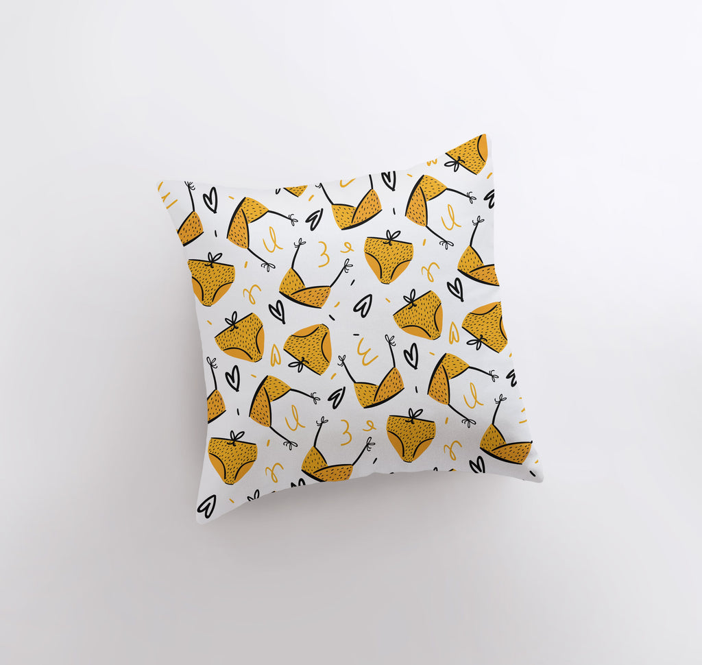 a white pillow with a yellow and black pattern on it