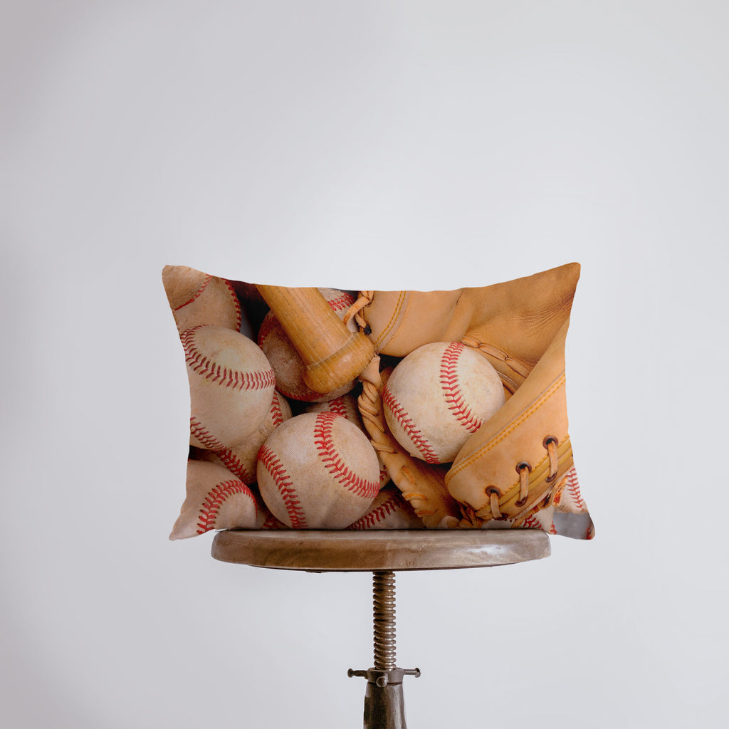 a pillow with baseballs and gloves on it