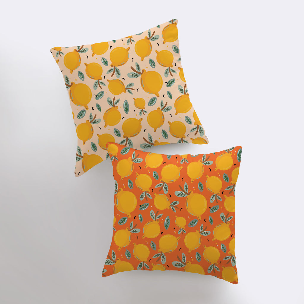 a pair of pillows with oranges on them