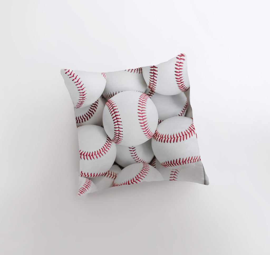 a bunch of baseballs sitting on top of a pillow