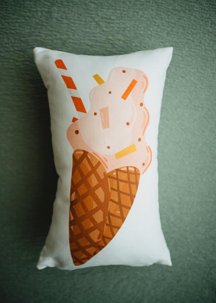 a pillow with an ice cream cone on it