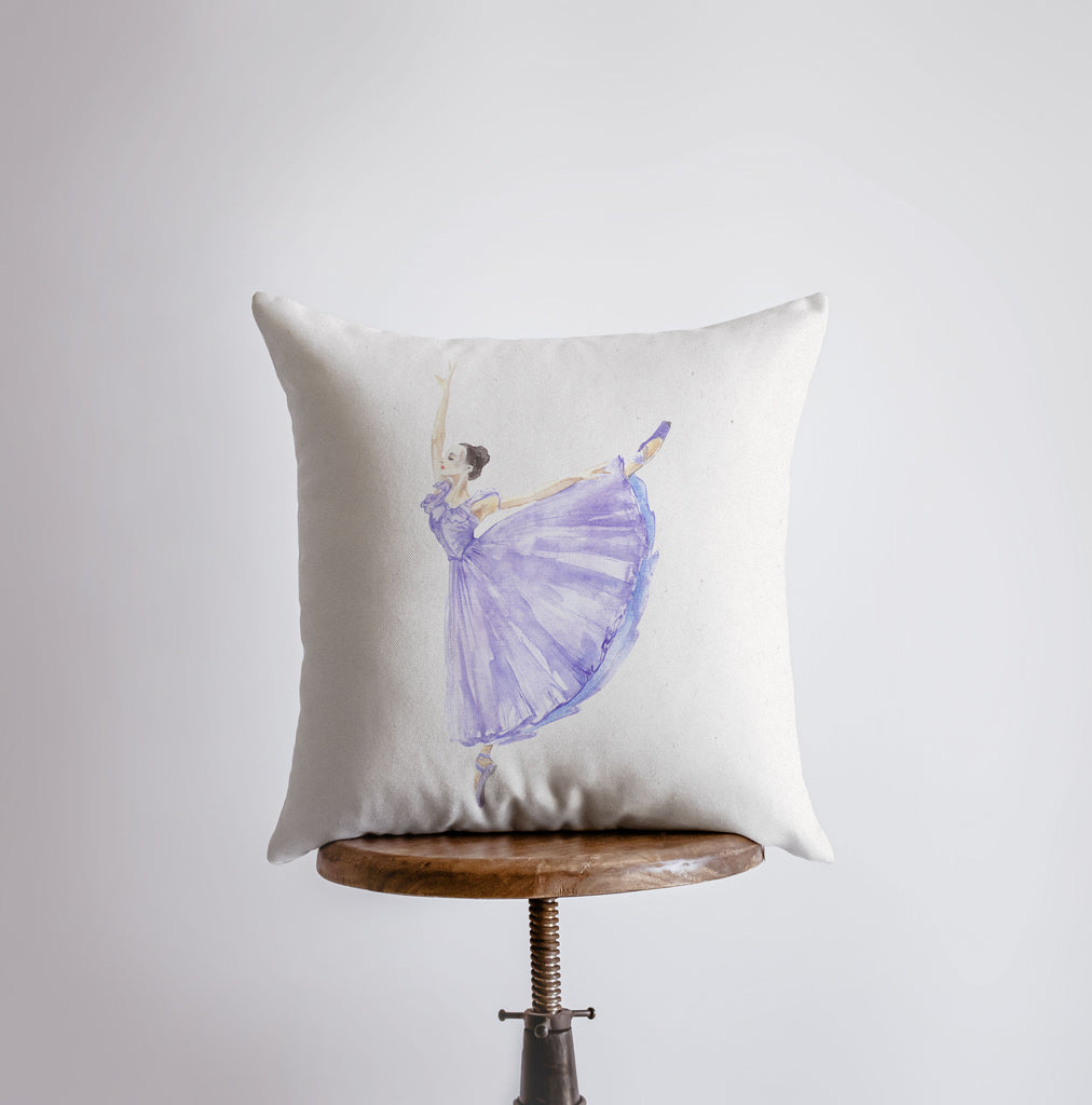 a white pillow with a purple ballerina on it