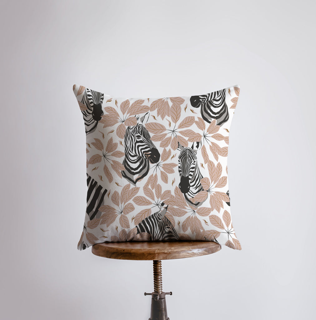 a pillow with zebras on it sitting on a chair