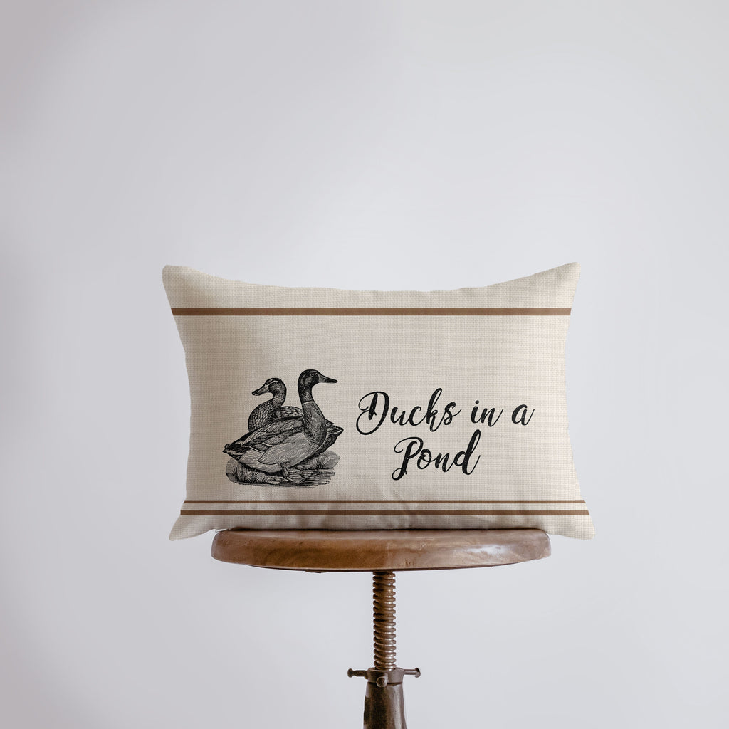 a pillow that has a duck in a pond on it