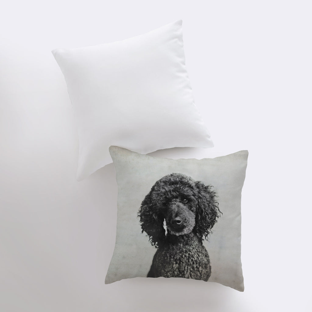 a pillow with a black poodle on it