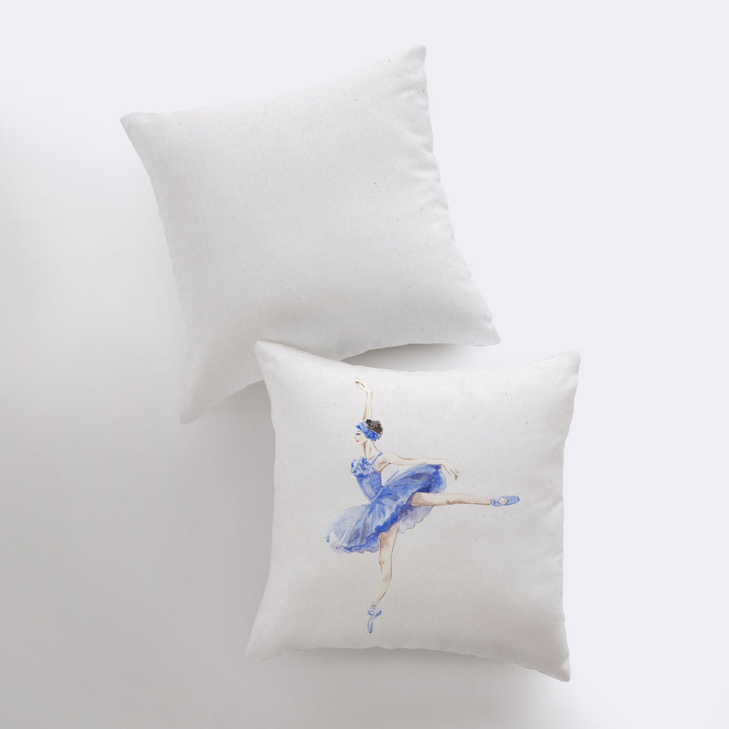 a pair of pillows with a ballerina painting on them