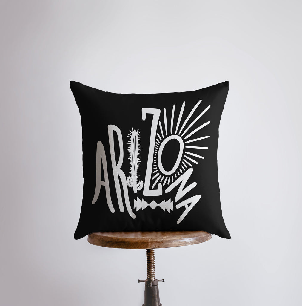 a black pillow sitting on top of a wooden table