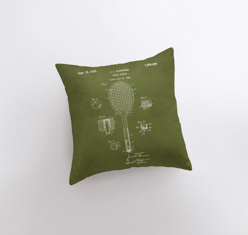 a green pillow with a tennis racket on it