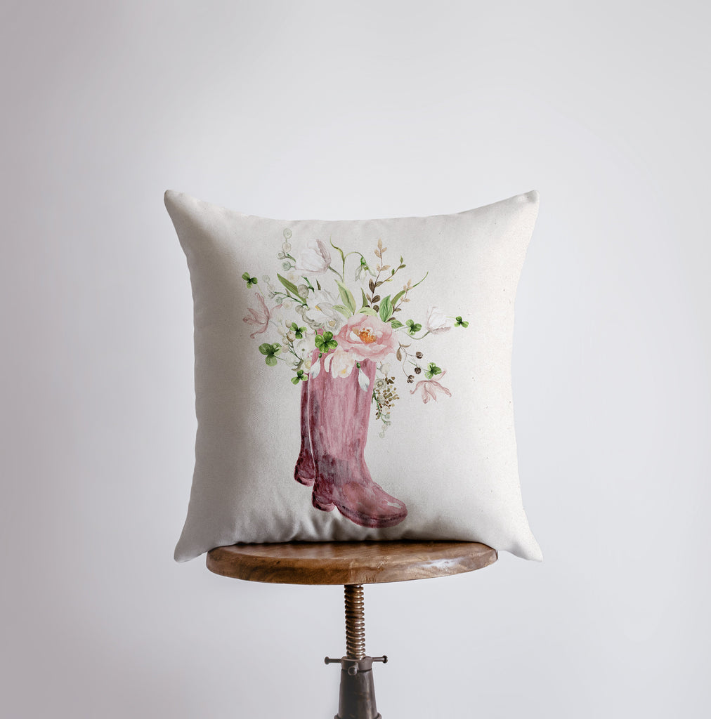 a pillow with a pink boot and flowers on it