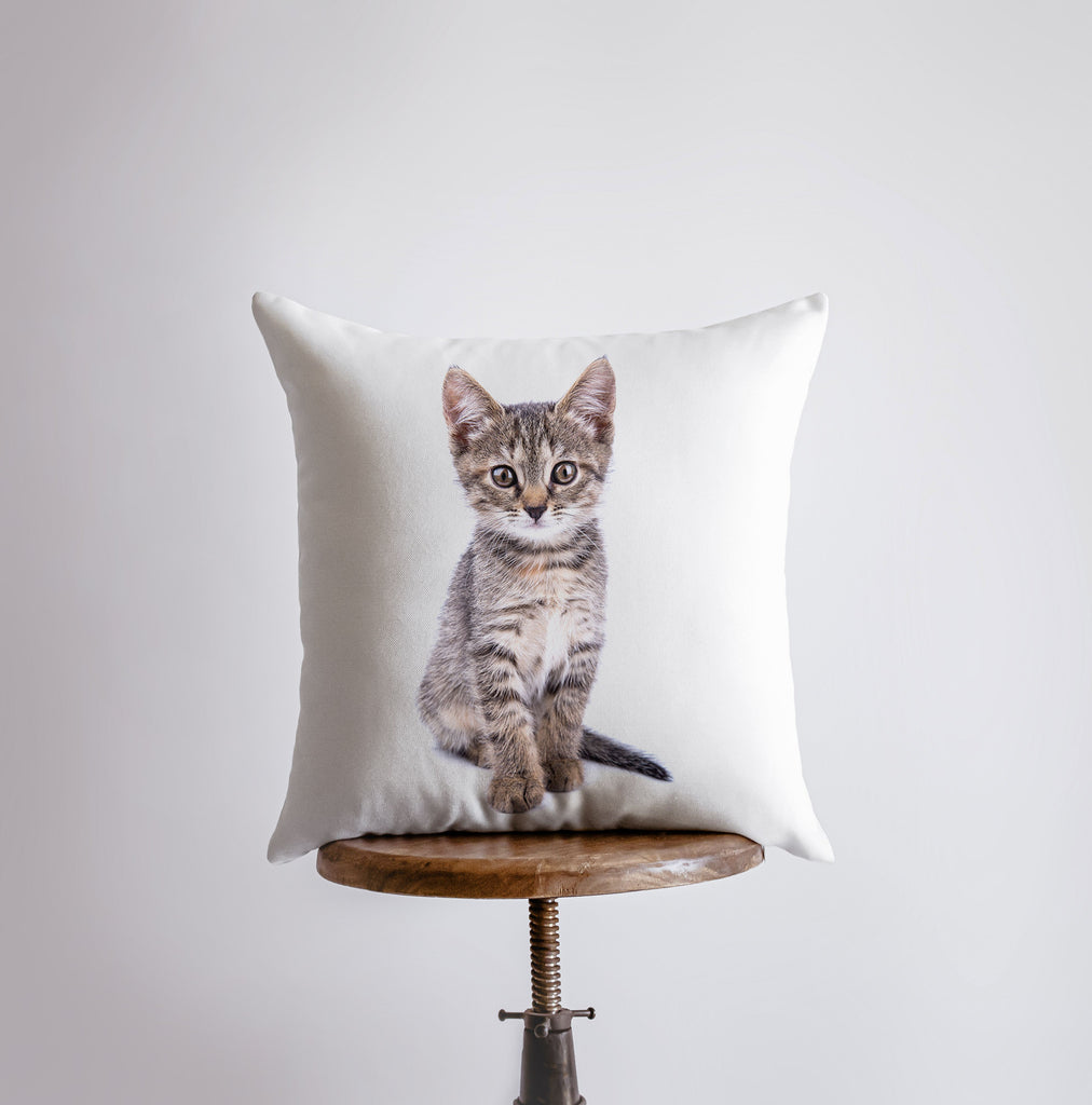 a pillow with a picture of a kitten on it