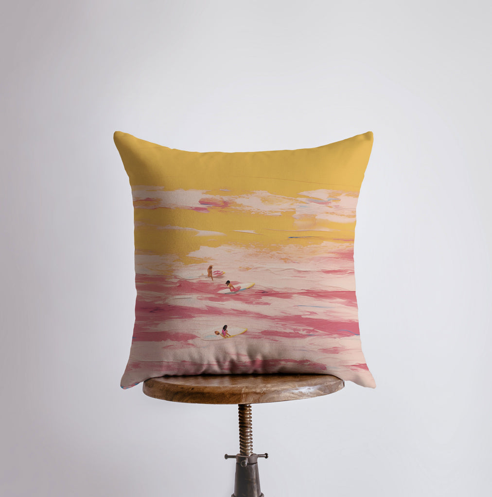 a yellow and pink pillow sitting on top of a table