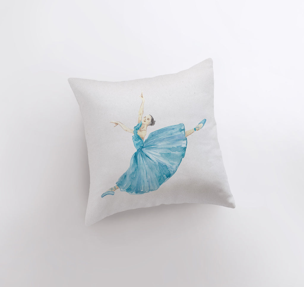 a white pillow with a blue ballerina on it