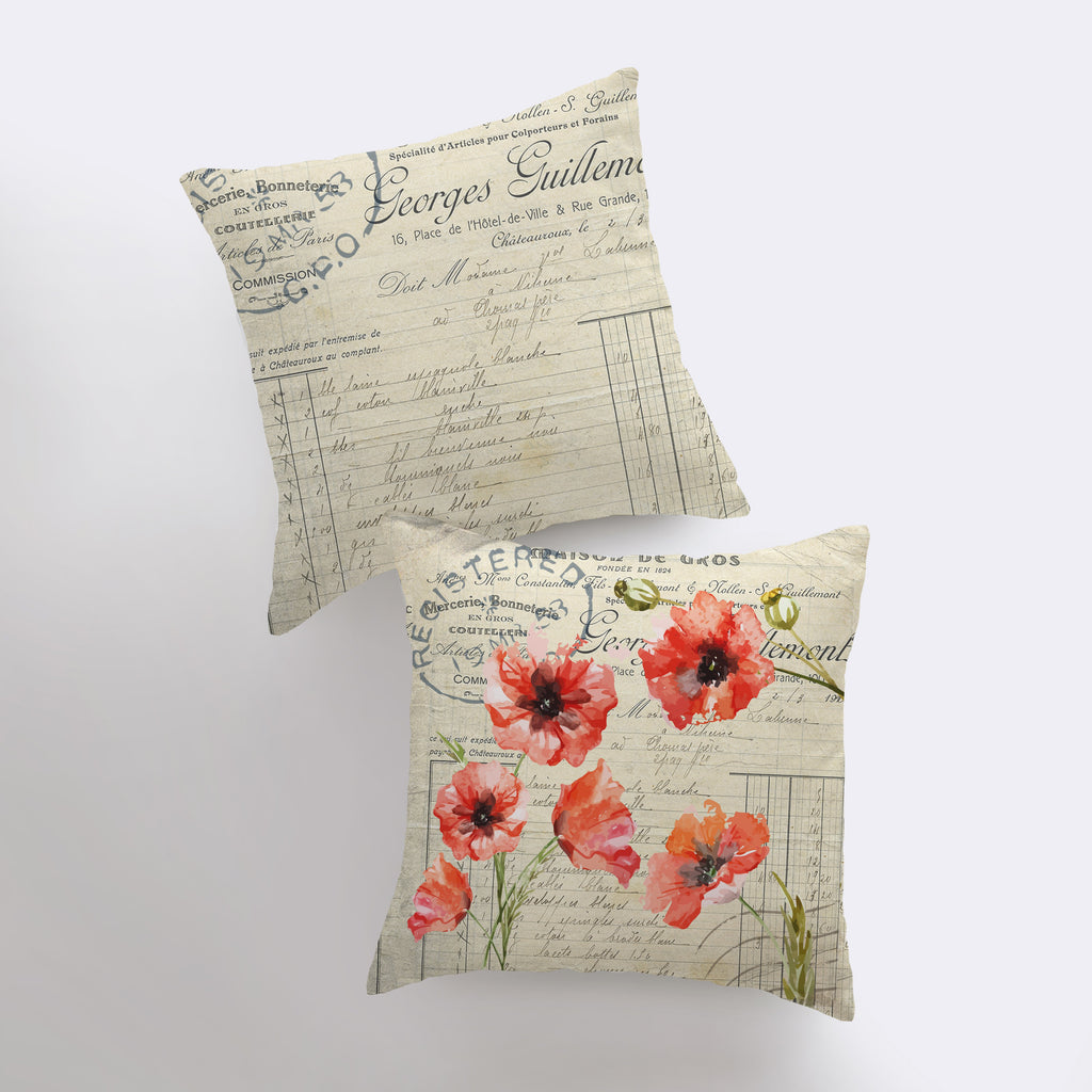 a pair of pillows with red flowers on them