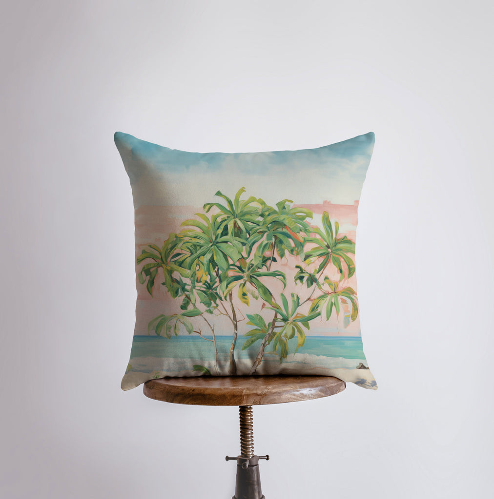 a pillow with a painting of a palm tree on it