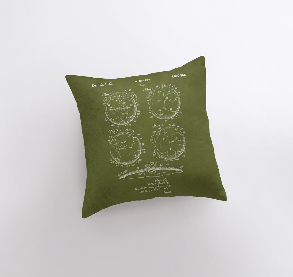 a green pillow with a drawing of three circles