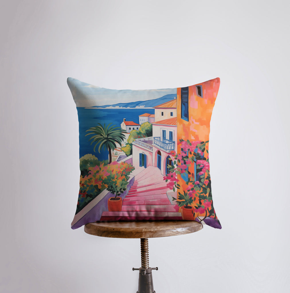 a pillow that has a painting of a house on it