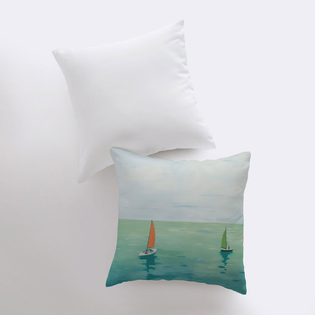 a pillow with two sailboats on the water