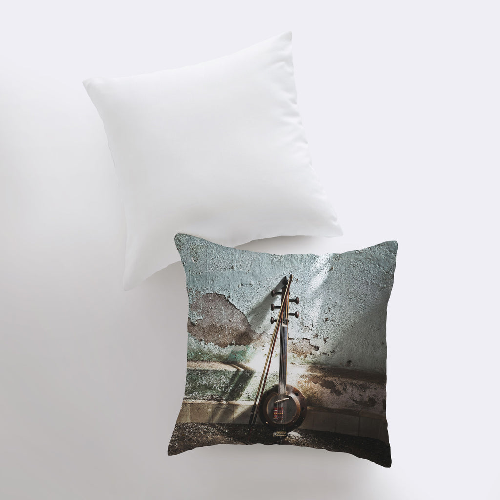 a pillow with a picture of a violin on it