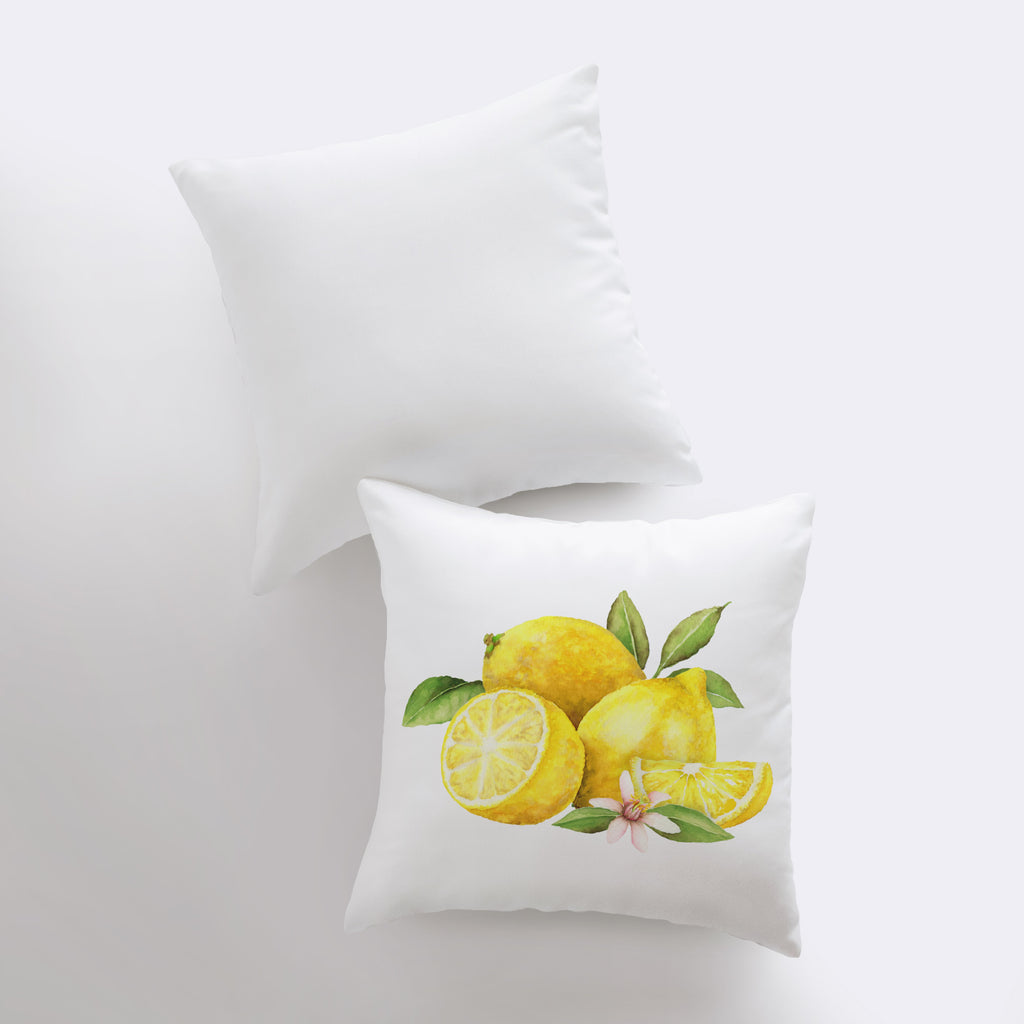 two pillows with lemons and leaves on them