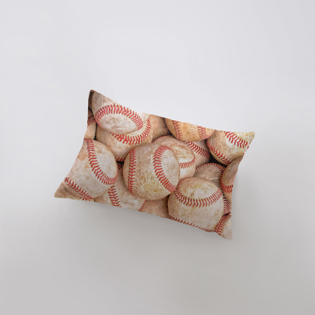 a pile of baseballs sitting on top of a pillow