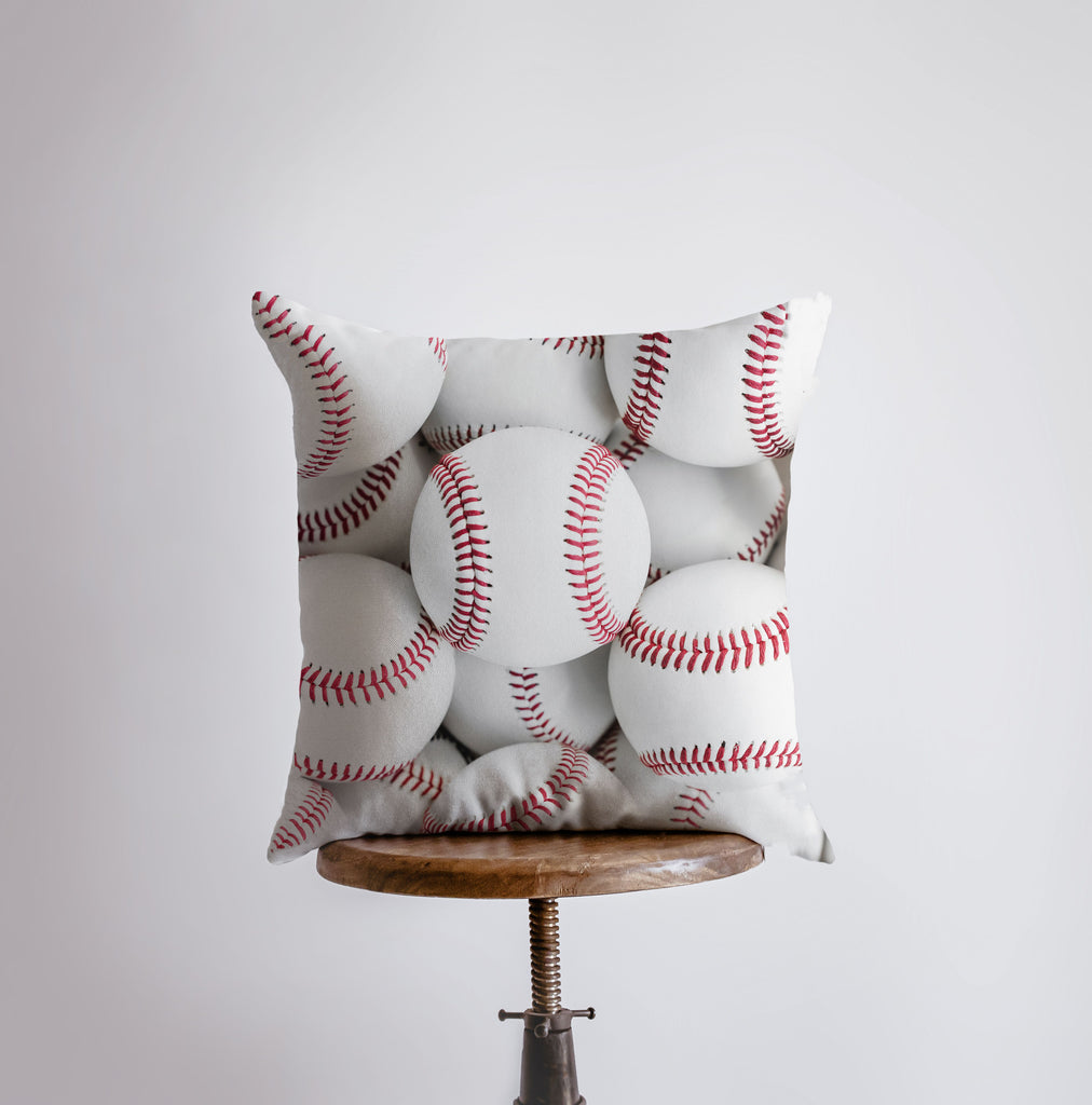 a bunch of baseballs on a pillow on a stool