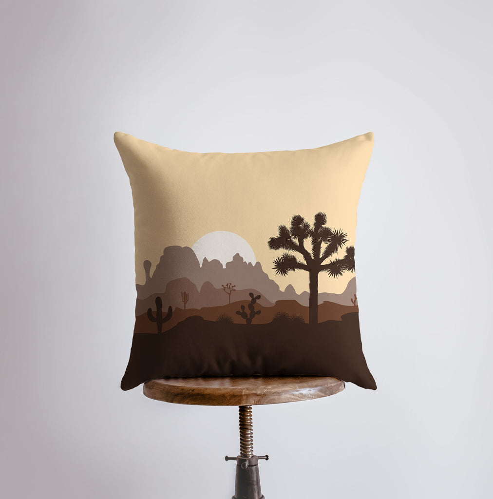 a pillow with a desert scene on it