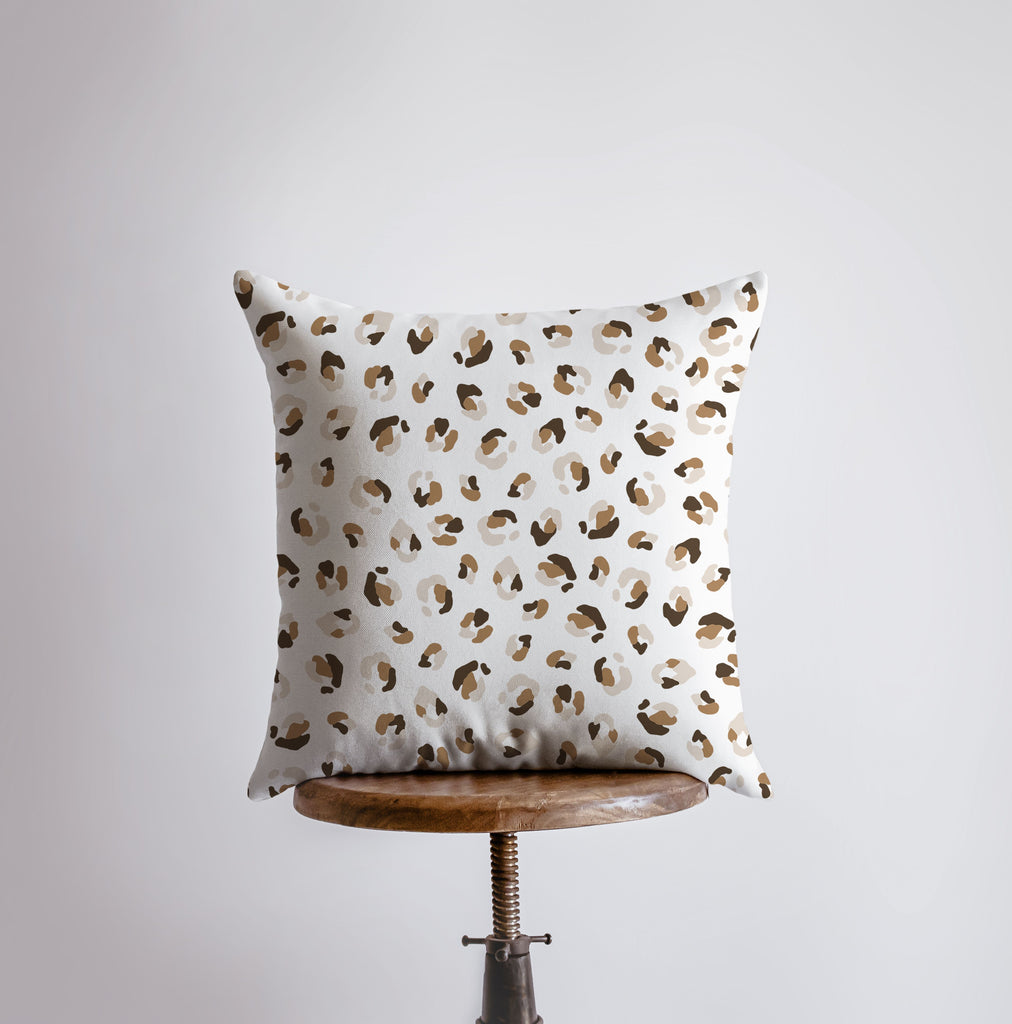 a white pillow with a leopard print on it