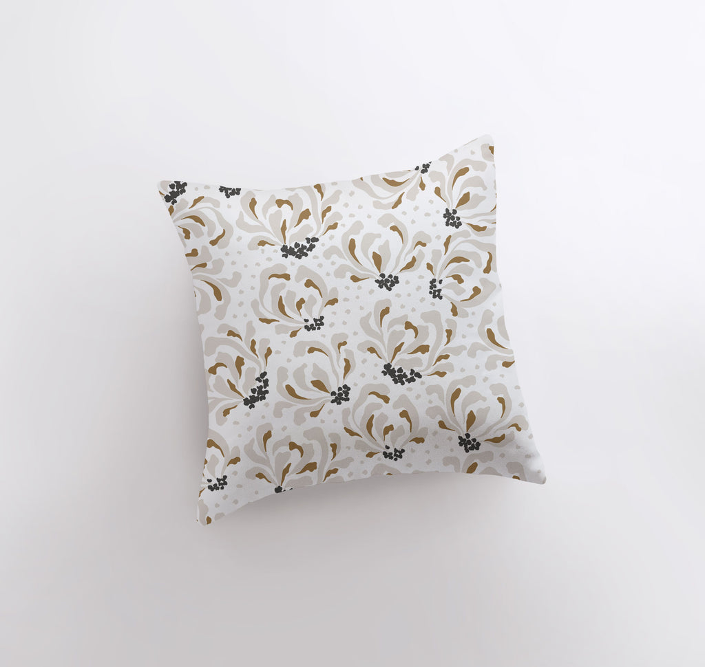 a white pillow with a gold and black pattern on it