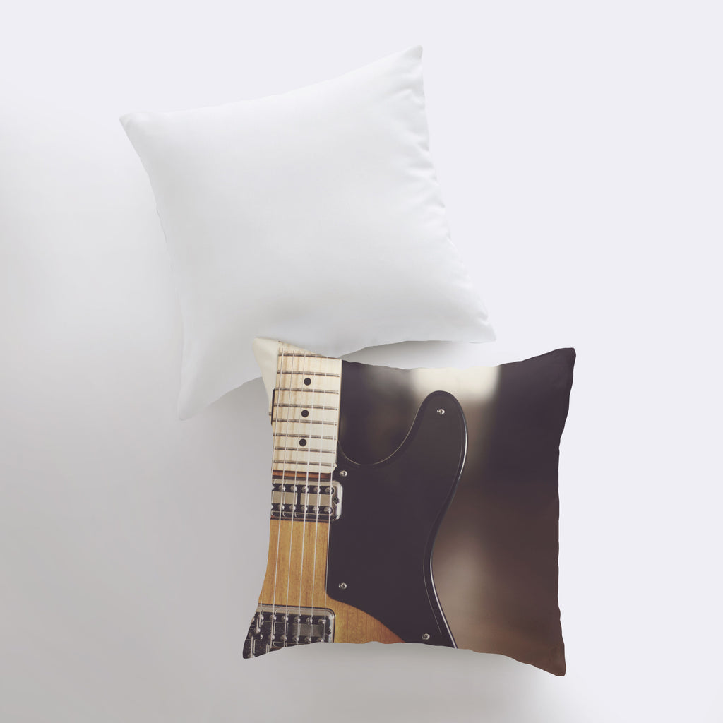 a pillow with a black guitar on it