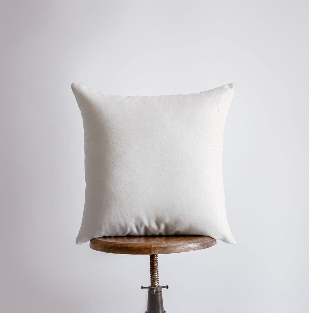 a white pillow sitting on top of a wooden table