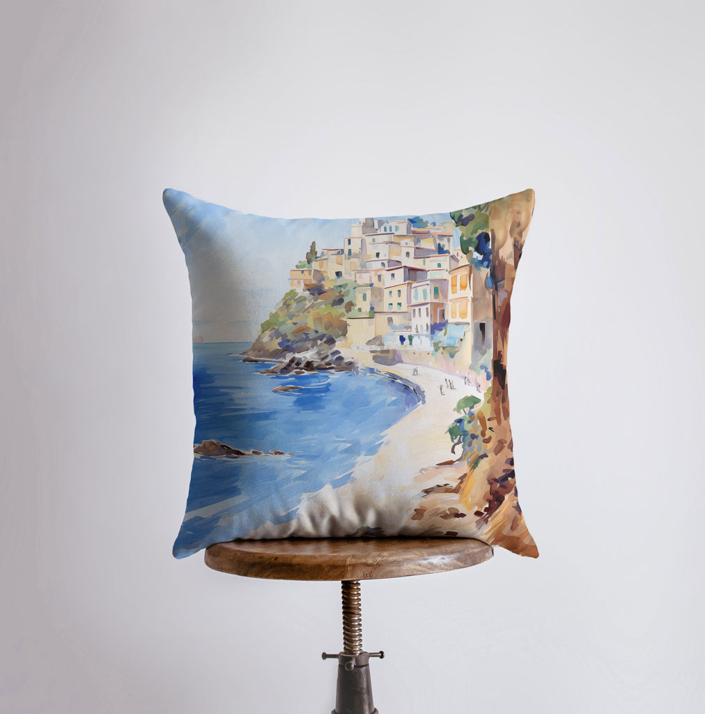 a pillow with a painting of a beach scene