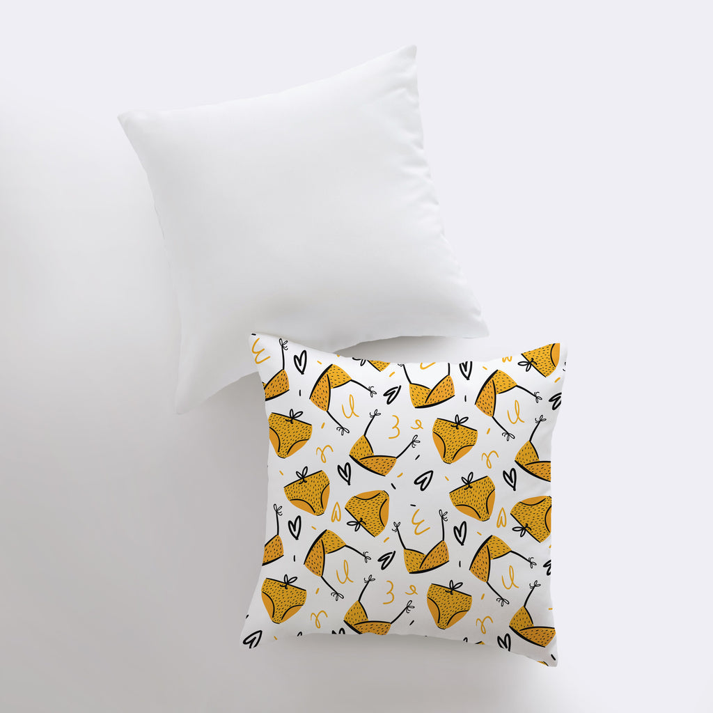 a white pillow with a yellow fox pattern on it