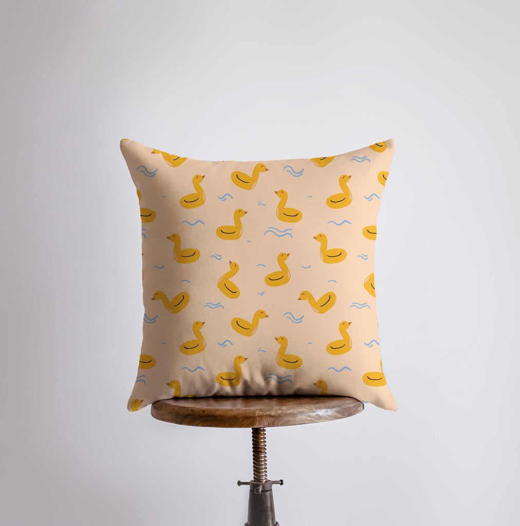 a pillow with a yellow duck pattern on it