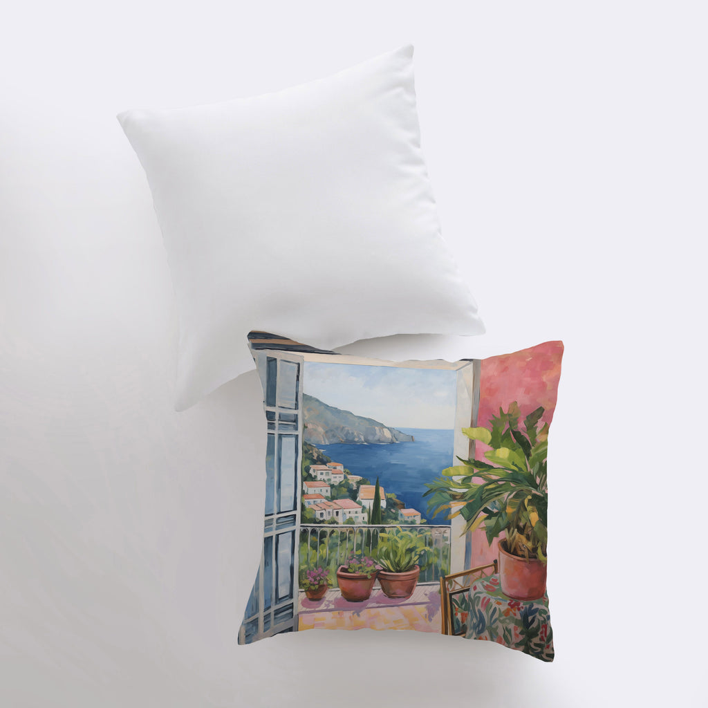 a pillow with a painting of a balcony with a view of the ocean