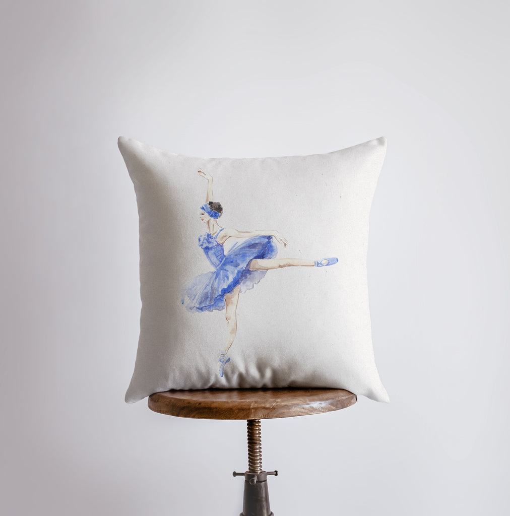 a white pillow with a blue ballerina on it