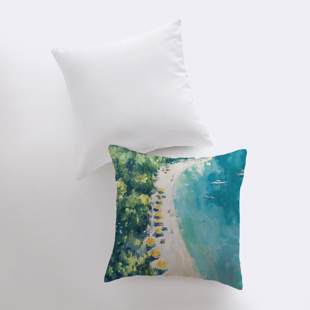 two pillows with a painting of a beach