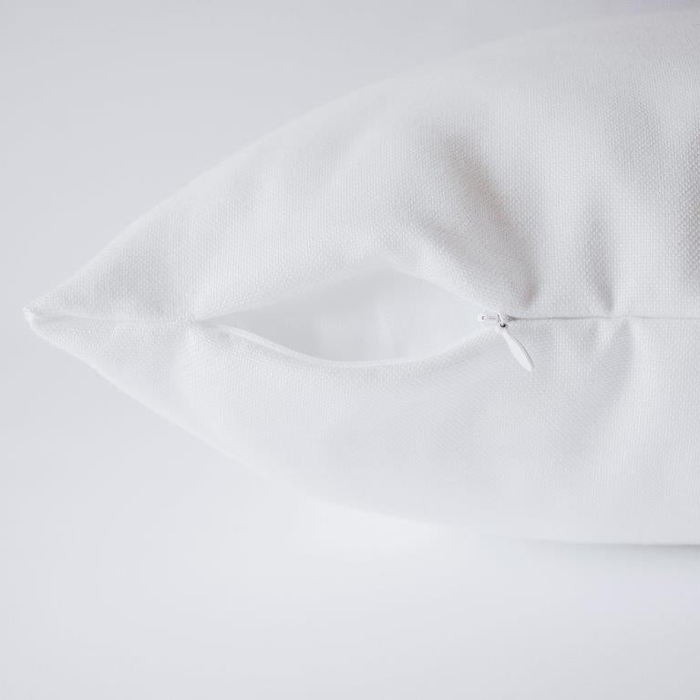 a close up of a white pillow on a white surface