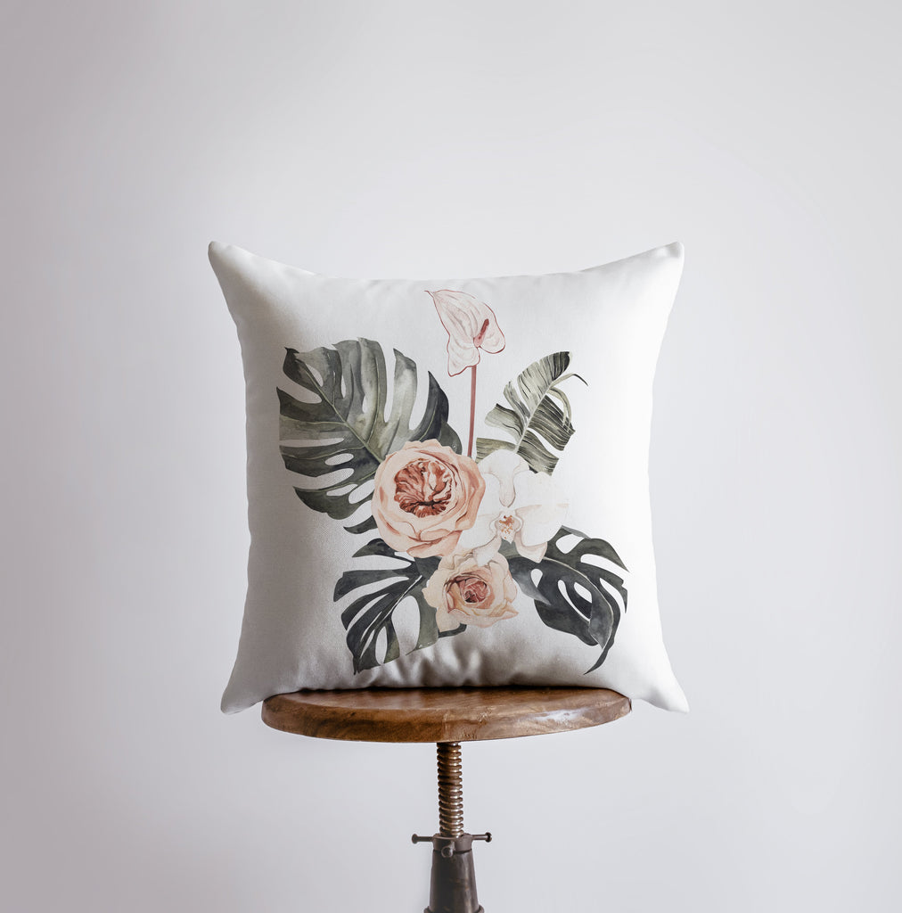 a white pillow with a floral design on it