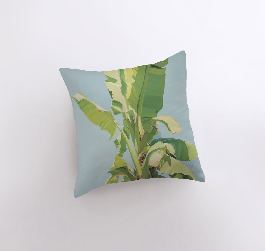 a pillow with a painting of a banana tree