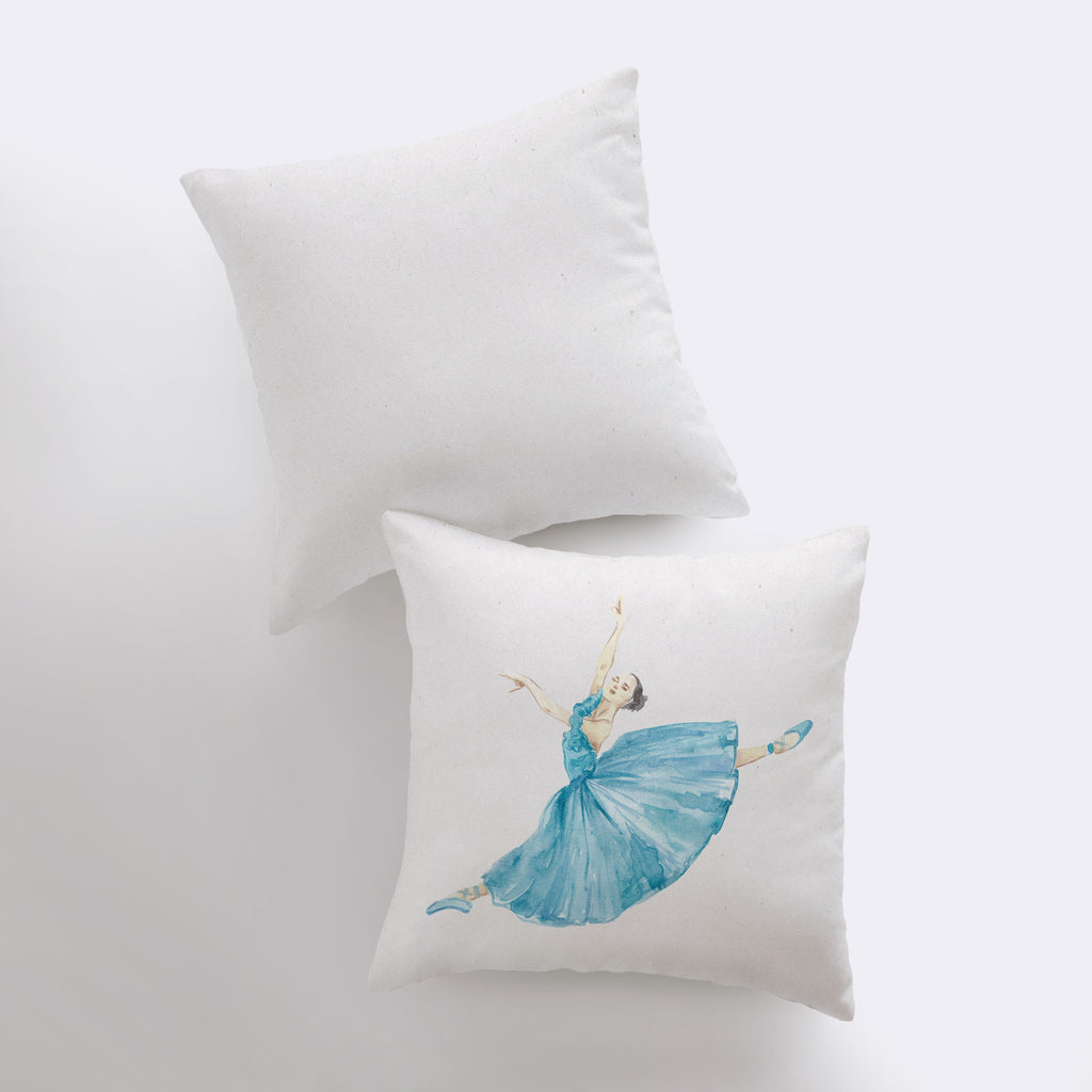 a pair of pillows with a ballerina in a blue dress