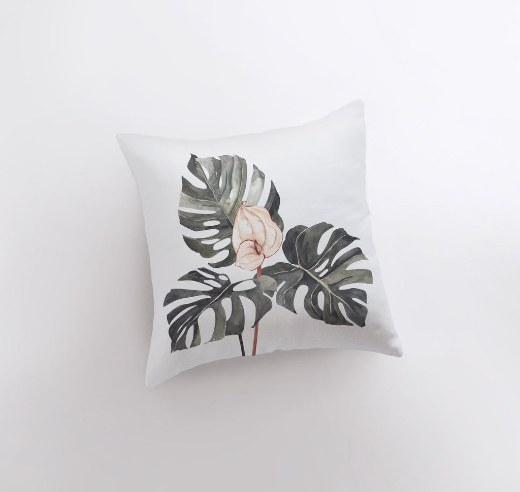 a white pillow with a pink flower on it