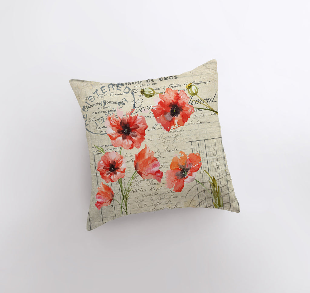 a pillow that has red flowers on it