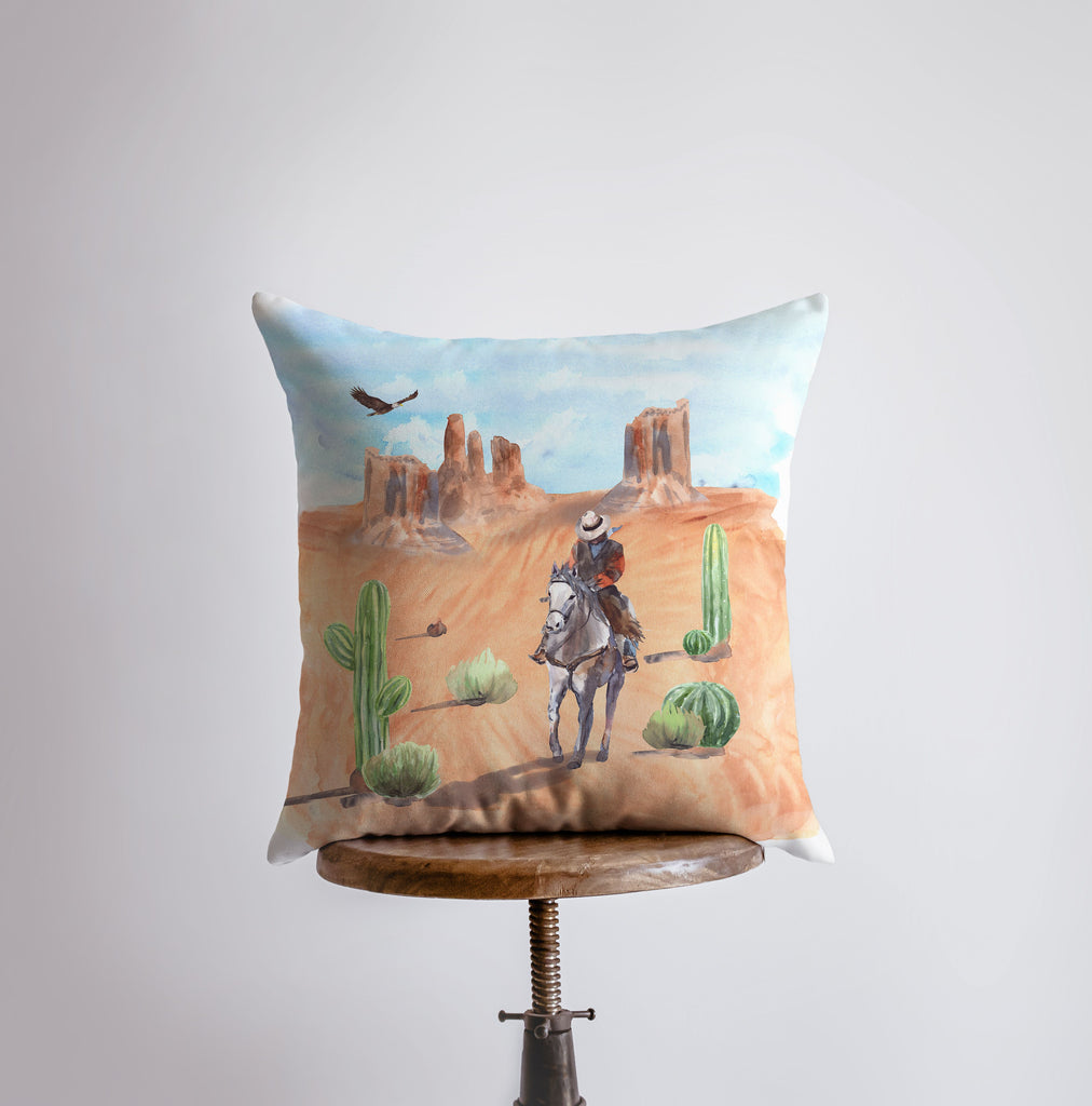 a pillow with a cowboy riding a horse in the desert