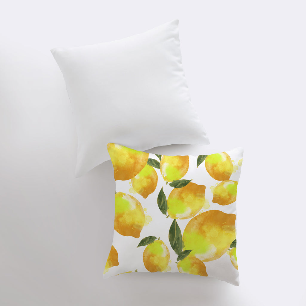 a white pillow with yellow lemons on it