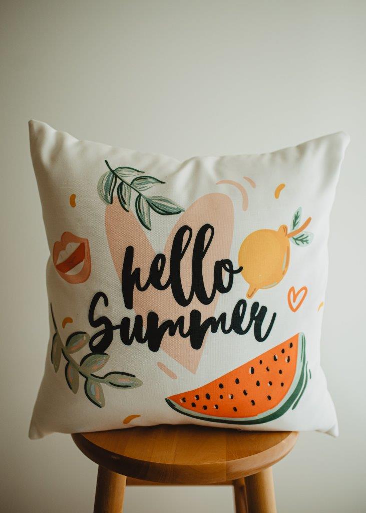 a pillow that says hello summer on it