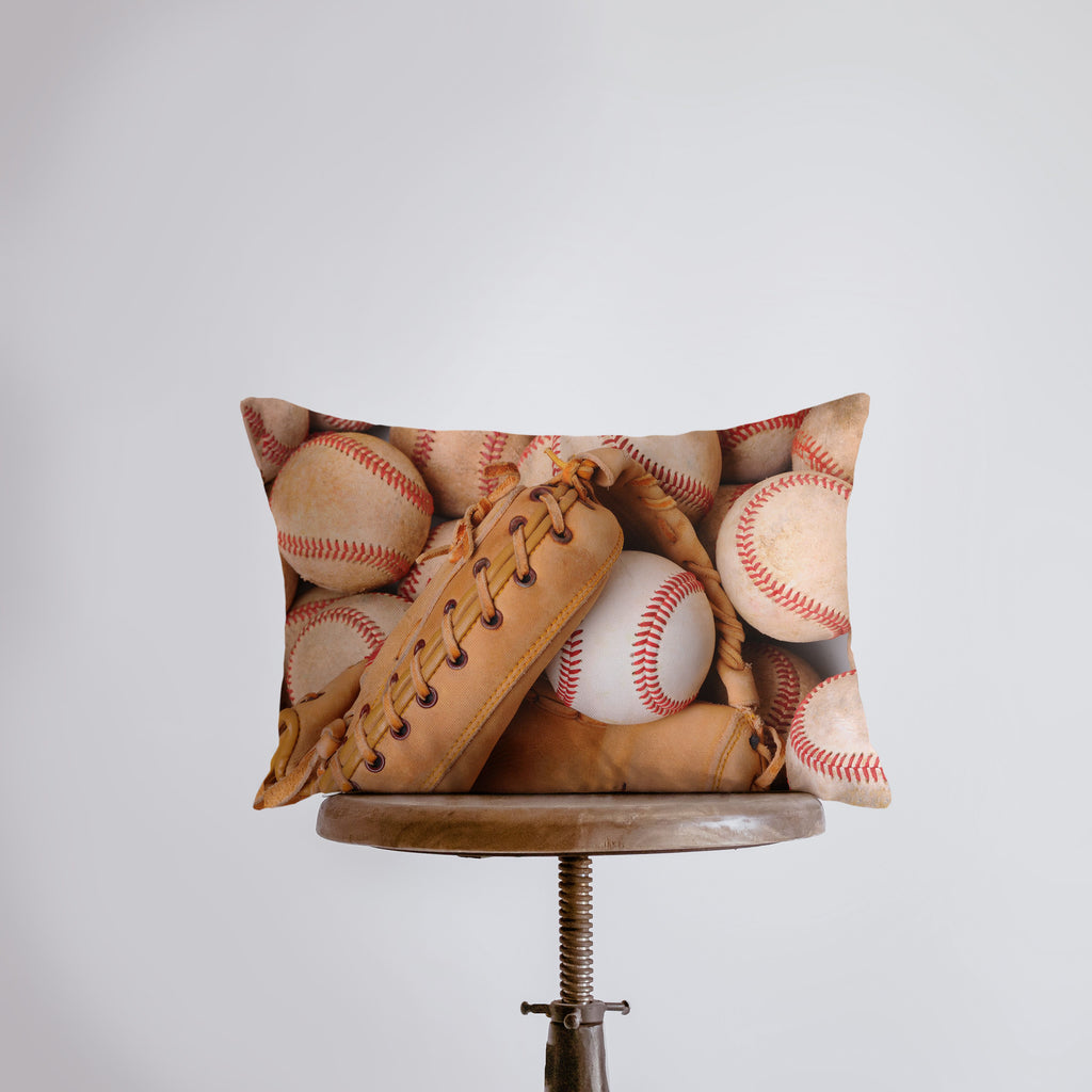 a pillow with baseballs and mitts on it