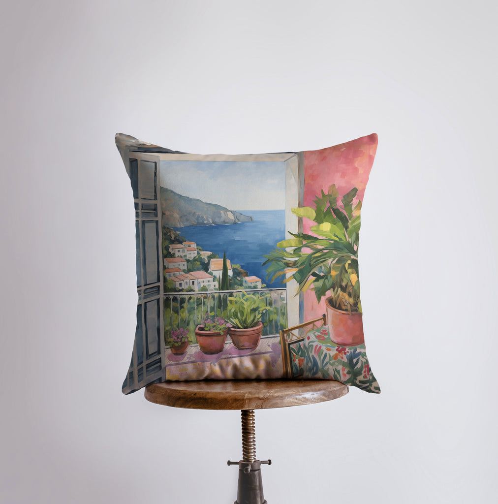 a pillow with a painting of a balcony with potted plants