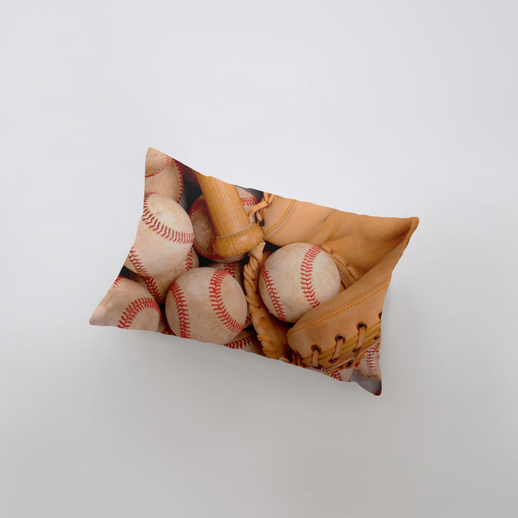 a pillow with a picture of baseballs and mitts on it