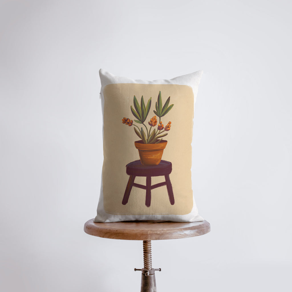 a pillow with a potted plant on it